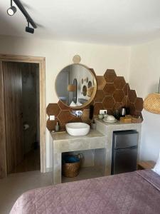 a bathroom with a sink and a mirror at Exclusive Del Mare Hotel in Sidari +13 photos