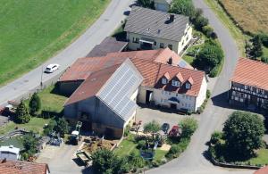 an aerial view of a house with solar panels on its roof at Ferienhof Zinn in Lauterbach