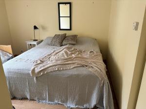 a bedroom with a bed with a white blanket at Spacious holiday home in Ellos 300 m to a beautiful sandy beach in Ellös +13 photos