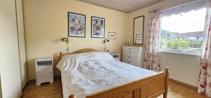 a bedroom with a bed and a window at Spacious holiday home in Ellos 300 m to a beautiful sandy beach in Ellös
