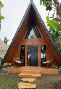 a small house with a triangular roof at A-Frame tiny house in Arusha