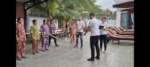 a group of people standing on a patio at The Step Hotel kampot in Kampot +49 photos