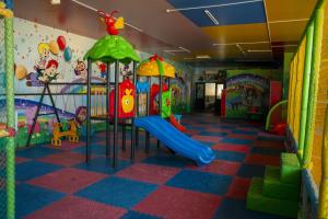 a play room with a slide and a playground at Tarlan Hotel in Aktau