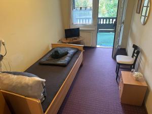 a bedroom with a bed and a desk and a chair at Motel Zur Festwiese in Gierstädt