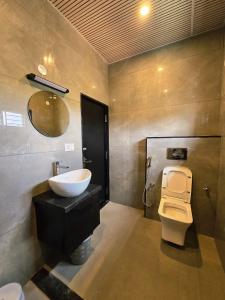 a bathroom with a sink and a toilet at SDK Residency in Shravanabelagola +33 photos