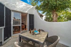 a wooden table with chairs on a patio at Villa Valentina in Carvoeiro