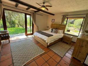 a bedroom with a bed and a large window at Sanctuary of The Heart in Fourways