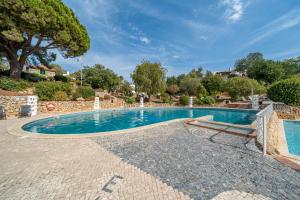 a swimming pool in a villa with a tree at Villa Valentina in Carvoeiro