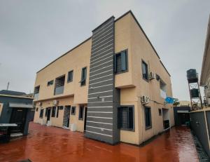 a building on a flooded street with water at Rhema Apartments in Lagos
