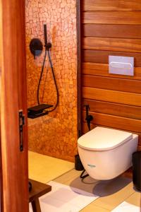 a bathroom with a toilet and a shower at Naya Lodge in Mitsamiouli +21 photos