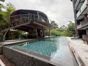 a swimming pool with a building with a stair in it at Emerald Terrace Resort 622 in Patong Beach
