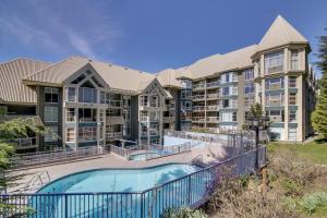 a view of an apartment complex with a swimming pool at The Woodrun Lodge by Whiski Jack in Whistler
