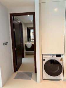 a bathroom with a washing machine and a sink at Emerald Terrace Resort 622 in Patong Beach +27 photos