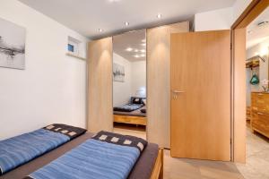 a bedroom with two beds and a sliding door at Cathleen Bohnert in Lindau