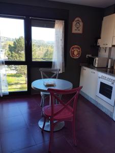 a kitchen with a table and a table and chairs at Acogedor apartamento en Noreña in Noreña +17 photos