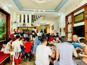 a crowd of people eating in a restaurant at Queen Motel Vung Tau in Vung Tau +25 photos