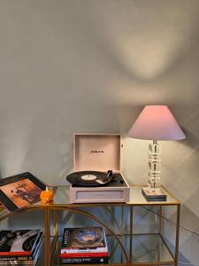 a table with a lamp and a record player on it at Il Sonetto - Boutique Apartment in Mantova +34 photos