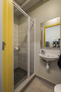 a bathroom with a sink and a shower at Peak Studios Cape Town in Cape Town +35 photos