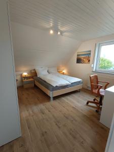 a bedroom with a bed and a desk and a window at Cozy apartment in Harsum near Hildesheim in Harsum