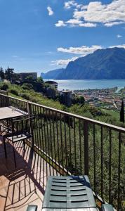 a balcony with a table and chairs and a view of a mountain at Appartamenti Nido d'Aquila - Garda Lake View in Nago-Torbole