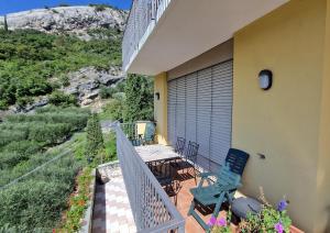 a balcony of a house with a table and chairs at Appartamenti Nido d'Aquila - Garda Lake View in Nago-Torbole