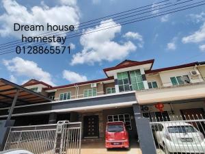 a red car parked in front of a house at Dream House Homestay in Sibu +2 photos