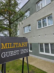 a sign for a military guest inn in front of a building at MILITARY Guest Inn in Drawsko Pomorskie