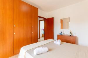 a bedroom with a bed with two towels on it at Dimora Riva Serena con Piscina in Torre Lapillo +34 photos
