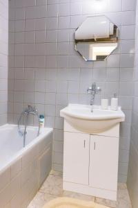 a bathroom with a sink and a bath tub at Apartmán MONTARA 23 in Donovaly