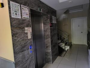 a elevator in a room with a wall of tiles at Hannapart Otel in Egirdir