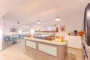 a large room with a counter and a restaurant at Hotel Boogaloo - Adults Only in El Arenal +42 photos
