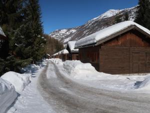 a road covered in snow next to a building at Residenz Edelweiss SAAS312 in Hollerbiel