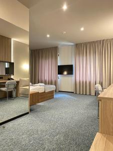a hotel room with a bed and a desk at Bogolvar Retreat Resort in Antonovka