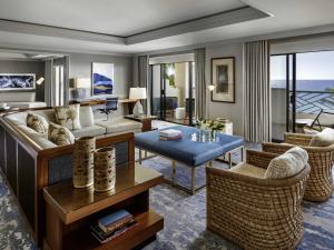 a living room with a couch and a table at Fairmont Orchid in Waikoloa
