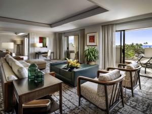 a living room with a couch and a table at Fairmont Orchid in Waikoloa