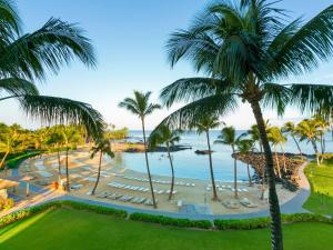 a view of a beach with palm trees and the ocean at Fairmont Orchid in Waikoloa