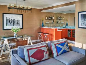 a living room with a couch and a table at Fairmont Miramar Hotel & Bungalows in Los Angeles +187 photos