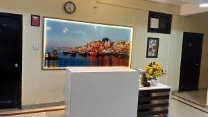 a large painting of a harbor on a wall at Hotel Sahu Near Kashi Vishwanath Temple Gate in Kashi