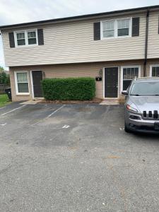 a car parked in a parking lot in front of a house at Runaway! in Charlotte