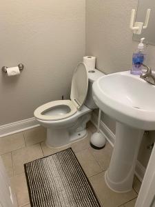 a bathroom with a white toilet and a sink at Runaway! in Charlotte +18 photos