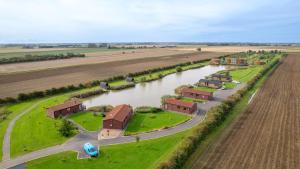 an aerial view of a farm next to a river at Lakeside Fishing Cabins in Boston +41 photos