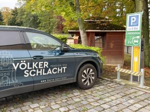 a van parked in front of a parking sign at Pension Völkerschlacht 1813 in Markkleeberg