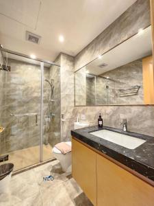 a bathroom with a sink and a shower and a toilet at R&F Princess Cove CIQ Premium Sea & City view Suites by NEO in Johor Bahru