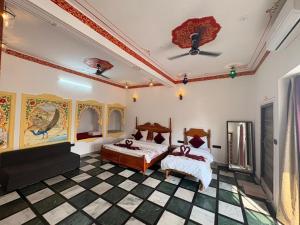 a bedroom with two beds and a checkered floor at Hotel Ushaan Haveli in Udaipur +110 photos