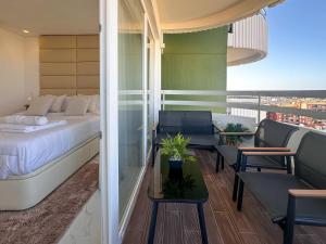 a hotel room with a bed and a table and chairs at Beira Mar, Portimão com Garagem e Piscina in Portimão