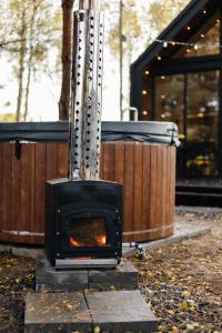 a stove is sitting on the ground in a yard at Forest Vibe Hotel&Spa in Kulʼchin