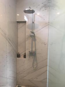 a shower with a shower head in a bathroom at M Villa in Bingin Beach