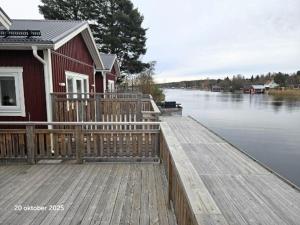 a house on a dock next to a body of water at Färjas Brygga in Söråker
