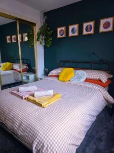 a bedroom with two beds with towels on them at Leith Double Rooms in Shared Flat Near The Shore and Tram in Edinburgh