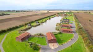 an aerial view of a building next to a river at Lakeside Fishing Cabins in Boston +32 photos